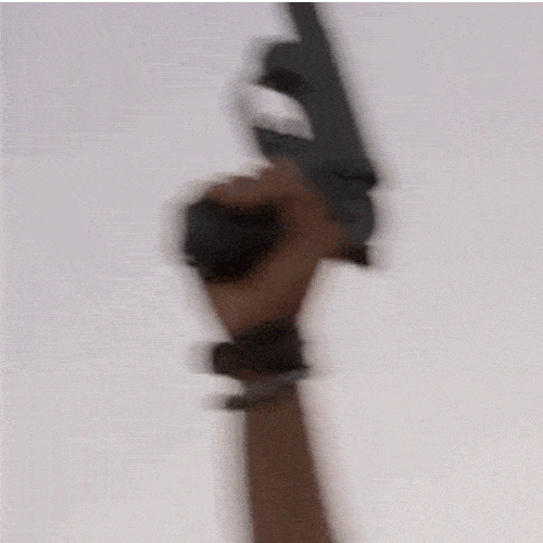 A hand shooting a flare up into the sky with a gun