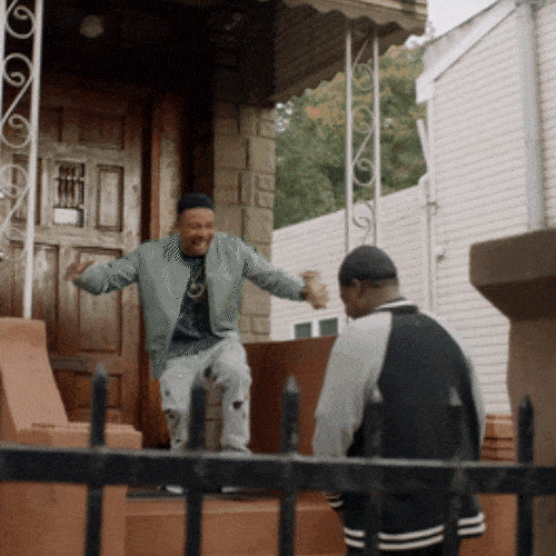 Two young men greeting each other enthusiastically 