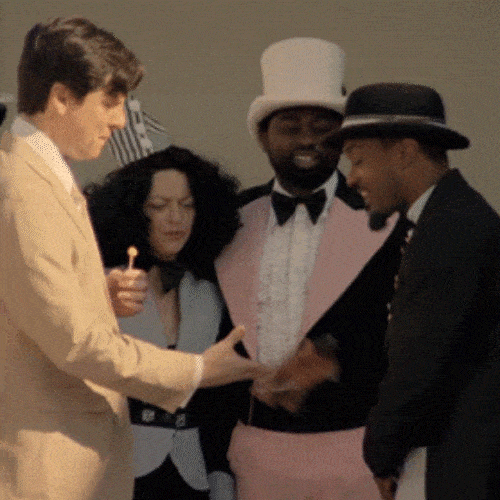 A black man and a white man shaking hands