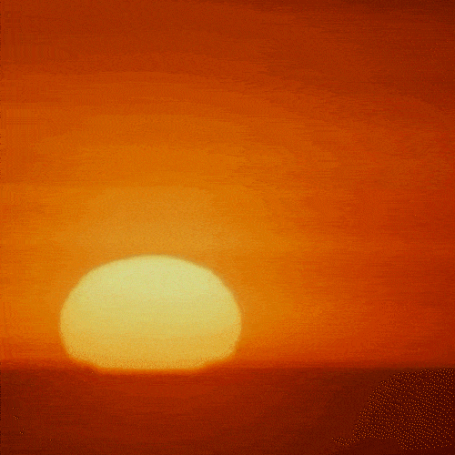 The sun rises over the horizon in an orange sky.