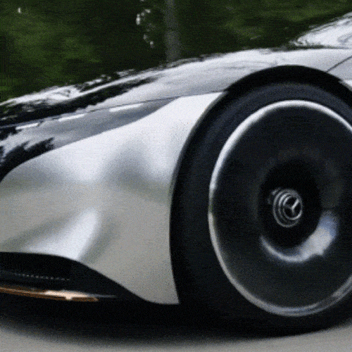 Close-up of a silver sports car wheel in motion