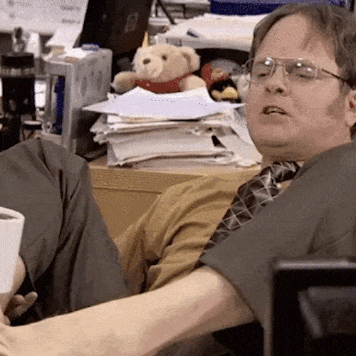 An office worker uses his toes to hold up a coffee mug.