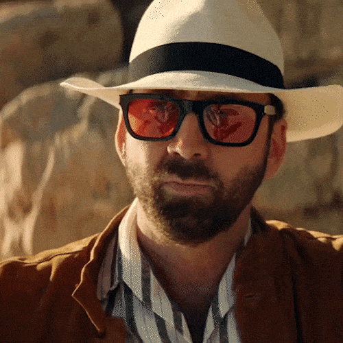 • Man wearing a white hat and sunglasses bowing and nodding