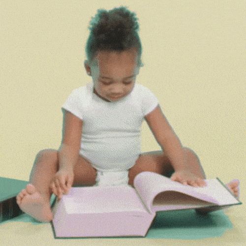 Young child sitting on the floor reading a book