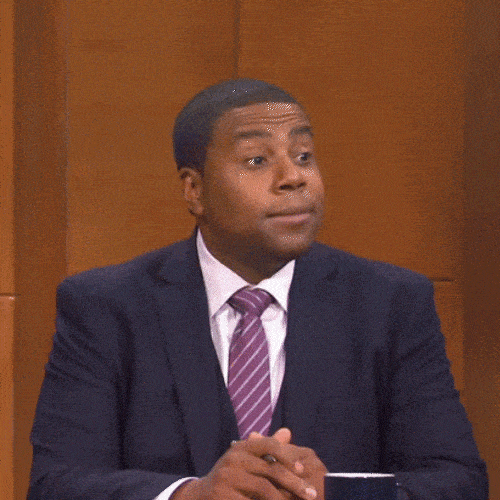Person in a suit nodding slightly while listening during a conversation