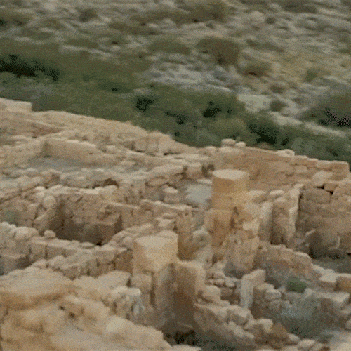 An aerial view of ancient stone ruins in a dry landscape.