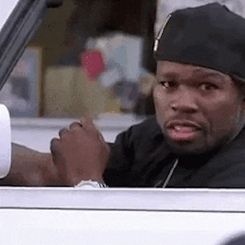 A man in a black cap waves goodbye from a car window and drives off.