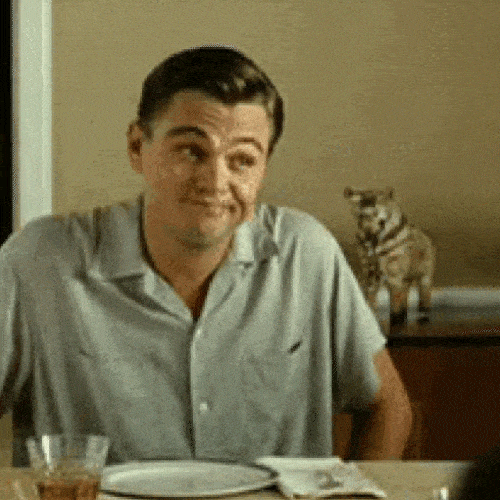 Man sitting at a dinner table, shrugging