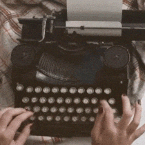Hands typing on a vintage typewriter, representing writing and content creation.