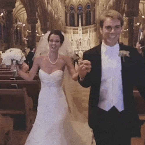 A newlywed couple walks back down a church aisle, and the groom takes a tumble.