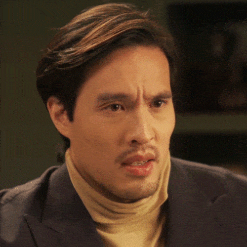Man in a turtleneck with an uncomfortable, apologetic expression