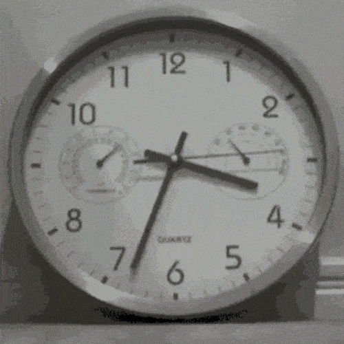 Analog wall clock with moving hands showing time passing