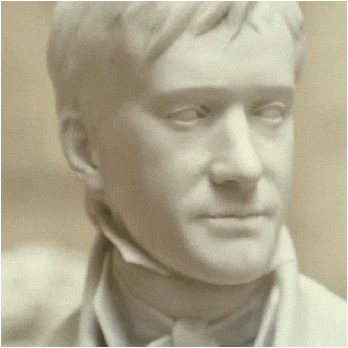 A close-up of a white marble statue of a man's head.