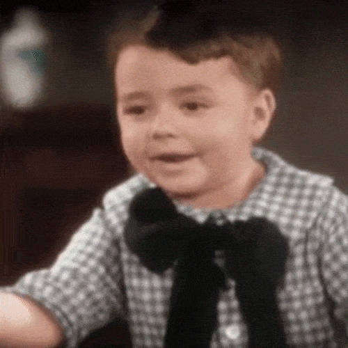 Young child pointing to his head to show he thinks smart