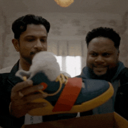 Two men admiring a colourful sneaker