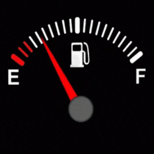 A close-up of a car's fuel gauge with the needle pointing near empty.
