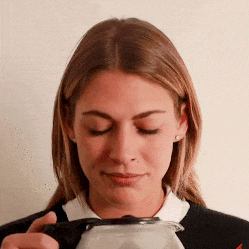 A woman drinks black coffee directly from the pot