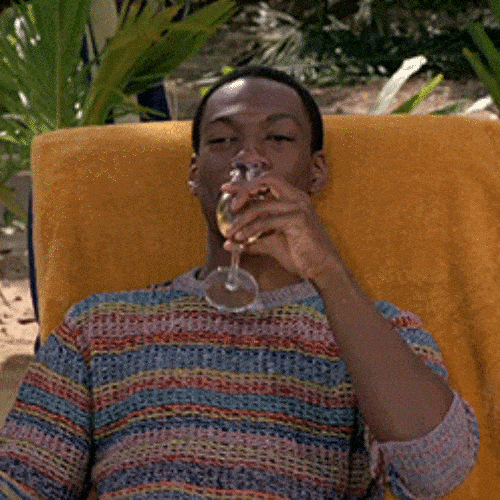 Man relaxing in a chair holding a glass of wine