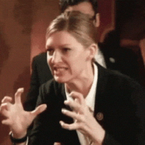 Woman grimacing with hands raised in frustration