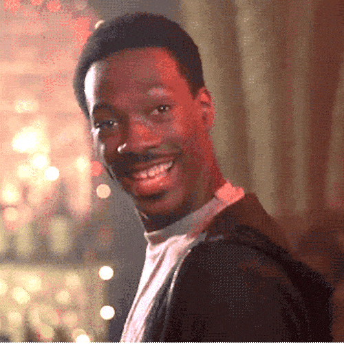 Man grinning broadly and showing okay sign