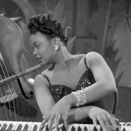 Woman playing piano in a vintage black and white clip