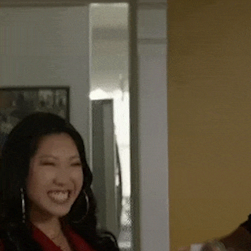 A smiling woman and man put their arms around each other.