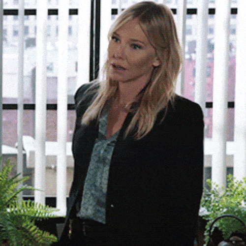Woman in a blazer looking exasperated 