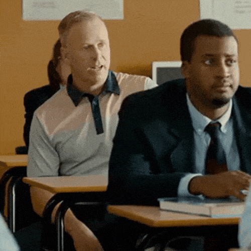 A student sitting in a classroom, looking confused